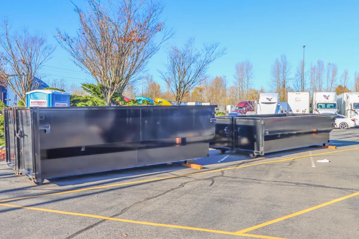Professional dumpster rental service with roll-off container on residential driveway in Carlisle